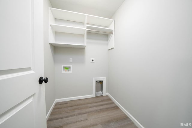 laundry area with hookup for a washing machine, hookup for an electric dryer, and light hardwood / wood-style floors