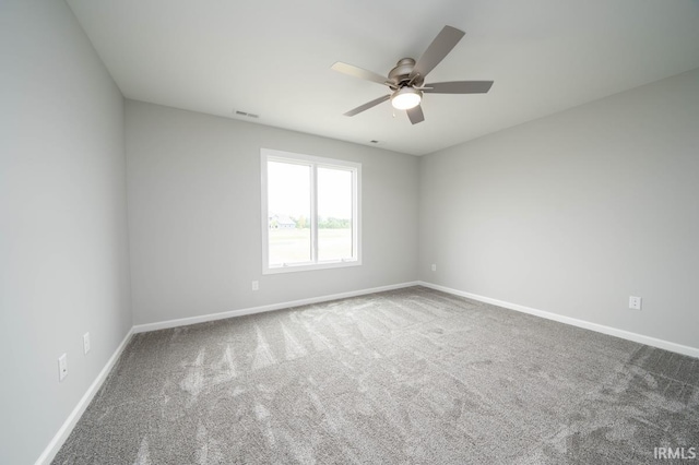 spare room featuring ceiling fan and carpet flooring