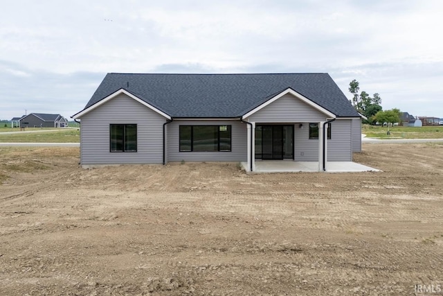 back of property with a patio