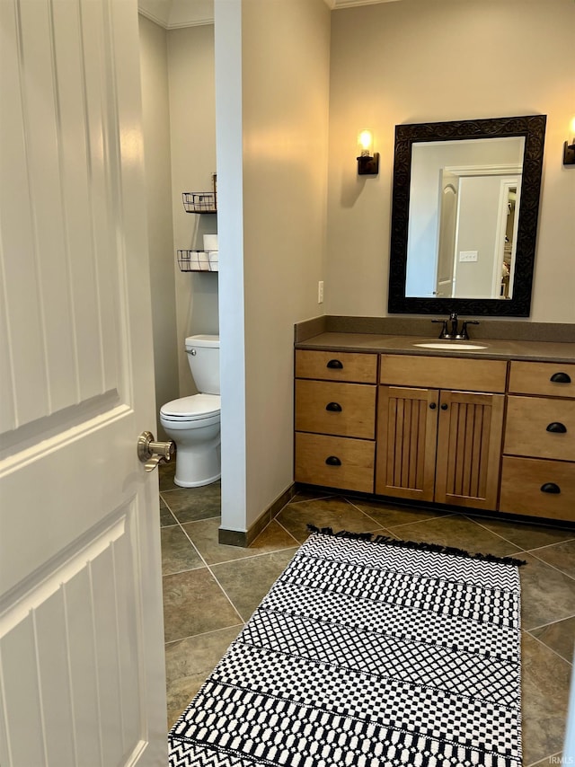 bathroom featuring tile patterned flooring, vanity, and toilet