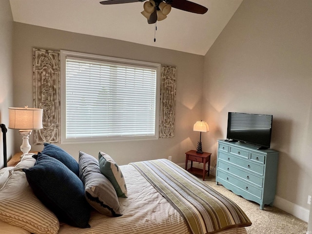 bedroom with light colored carpet, vaulted ceiling, and ceiling fan