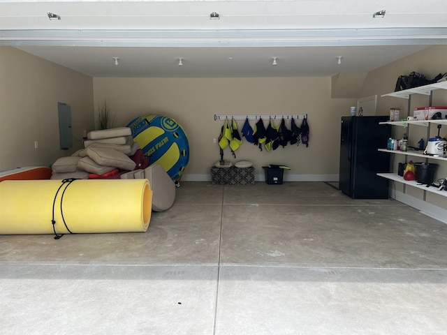 garage featuring black refrigerator and electric panel