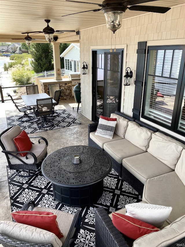 view of patio / terrace with ceiling fan, area for grilling, and an outdoor living space