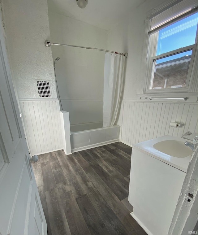 bathroom with sink, wood-type flooring, and shower / bath combo