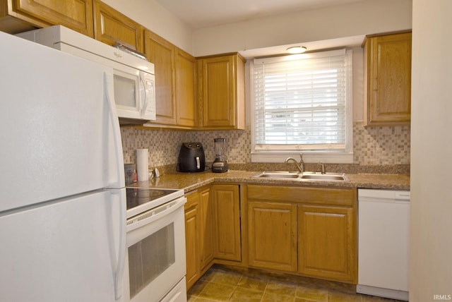 kitchen with light tile patterned flooring, backsplash, white appliances, and sink