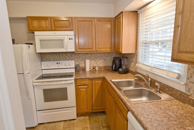 kitchen with sink, decorative backsplash, tile patterned flooring, and white appliances