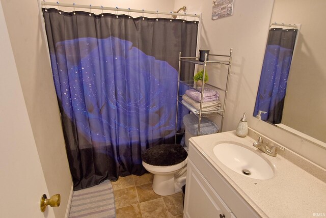 bathroom featuring tile patterned floors, toilet, and vanity