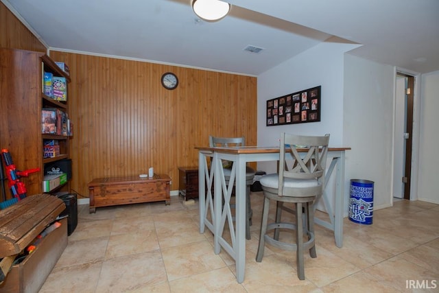 tiled dining room with wooden walls