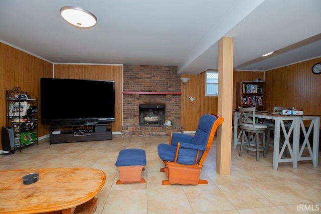 living room featuring wooden walls, a fireplace, and tile patterned flooring