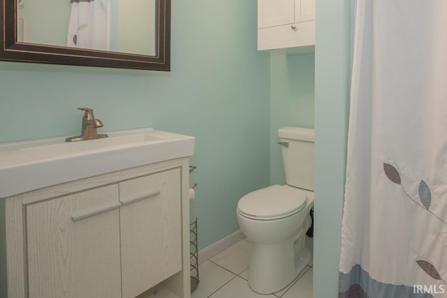 bathroom featuring toilet, tile patterned floors, and vanity