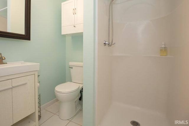 bathroom featuring a shower, tile patterned floors, vanity, and toilet