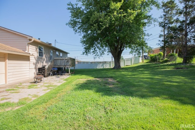 view of yard featuring an outdoor fire pit and a wooden deck