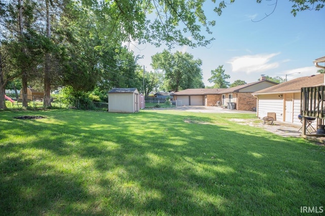 view of yard featuring a storage unit and a patio