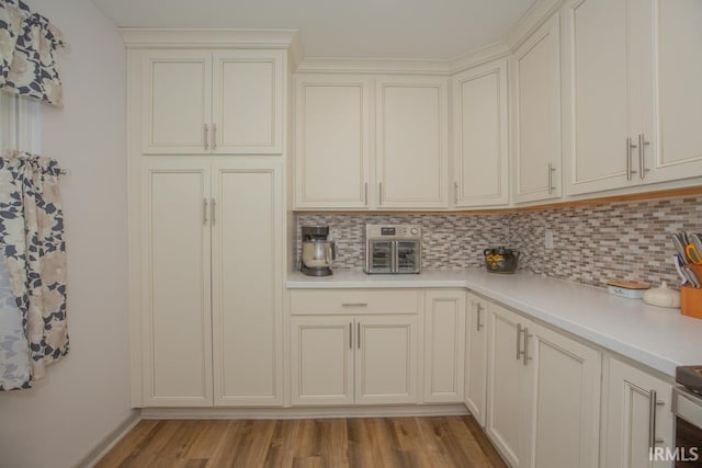 kitchen featuring light wood-type flooring and tasteful backsplash