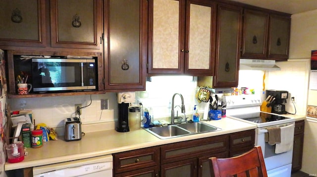 kitchen with white appliances, sink, and backsplash