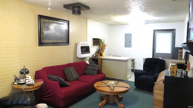 living room with electric panel, brick wall, and heating unit