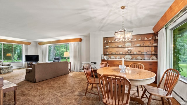 carpeted dining area with a notable chandelier and a baseboard radiator