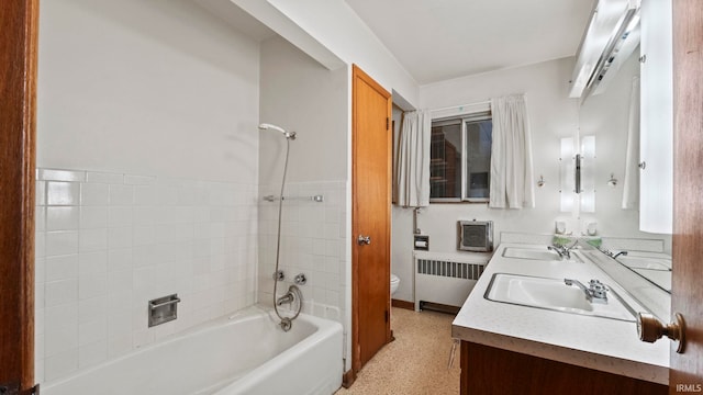 full bathroom with vanity, shower / washtub combination, toilet, and radiator