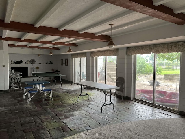 game room featuring beam ceiling