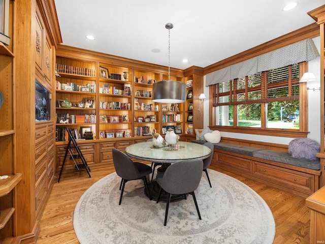 dining area featuring light hardwood / wood-style flooring and ornamental molding