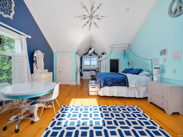 bedroom featuring light hardwood / wood-style floors, crown molding, and lofted ceiling