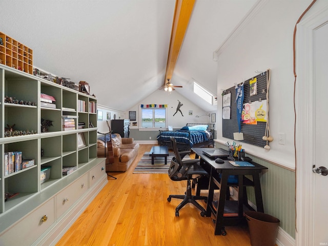 office space with ceiling fan, hardwood / wood-style floors, and vaulted ceiling with skylight