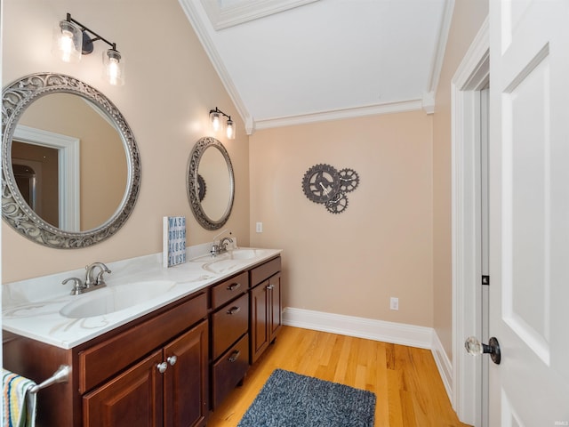 bathroom featuring vanity, wood-type flooring, ornamental molding, and lofted ceiling