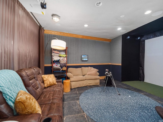 living room with crown molding and golf simulator