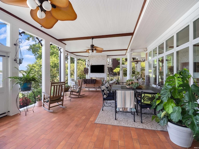 sunroom with beamed ceiling and ceiling fan