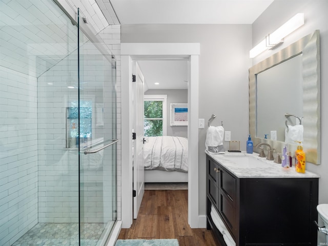 bathroom featuring hardwood / wood-style floors, vanity, and an enclosed shower