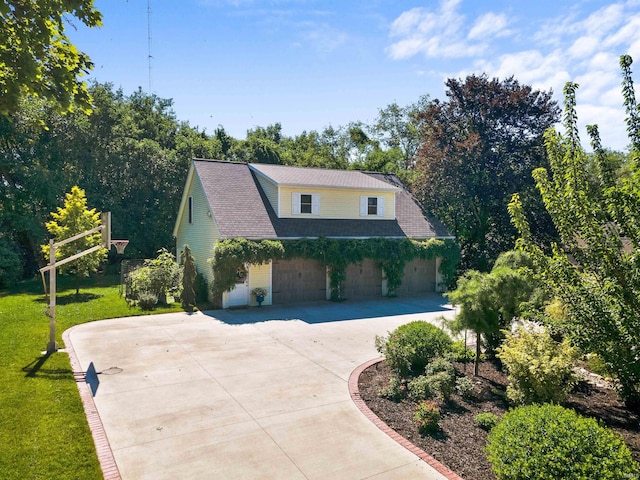 view of side of property featuring a garage and a yard