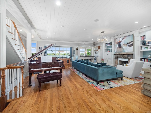 living room with light wood-type flooring, built in shelves, crown molding, wooden ceiling, and a stone fireplace