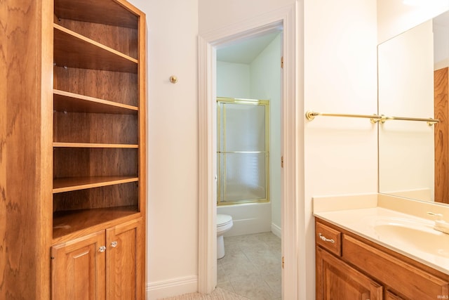 full bathroom featuring toilet, tile patterned floors, shower / bath combination with glass door, and vanity