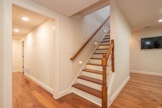 stairway featuring light hardwood / wood-style floors