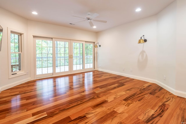 empty room featuring hardwood / wood-style flooring and ceiling fan