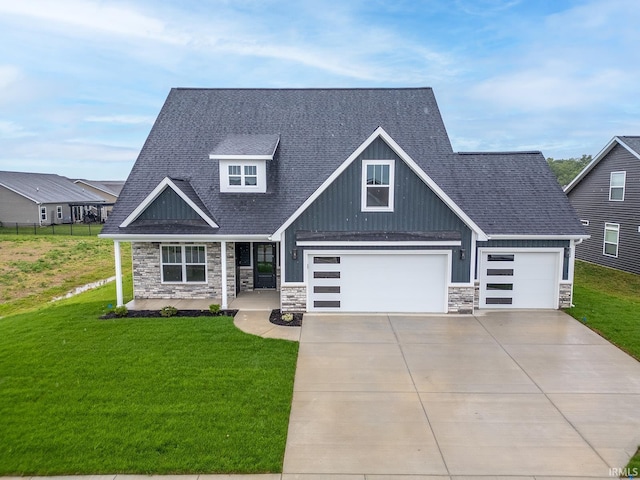 craftsman inspired home featuring a front yard and a garage