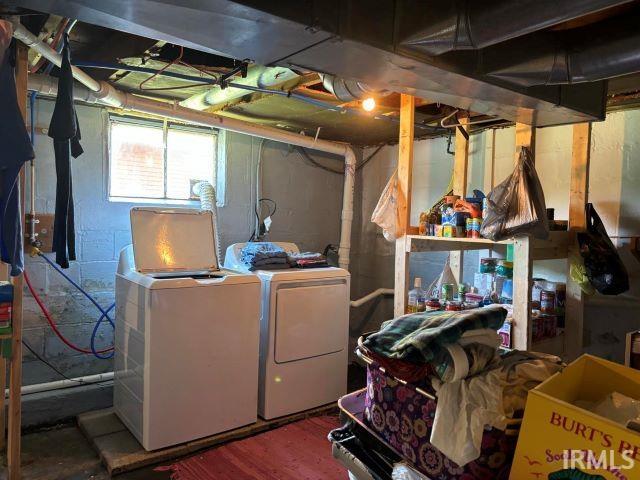 below grade area featuring washer and clothes dryer and wood finished floors