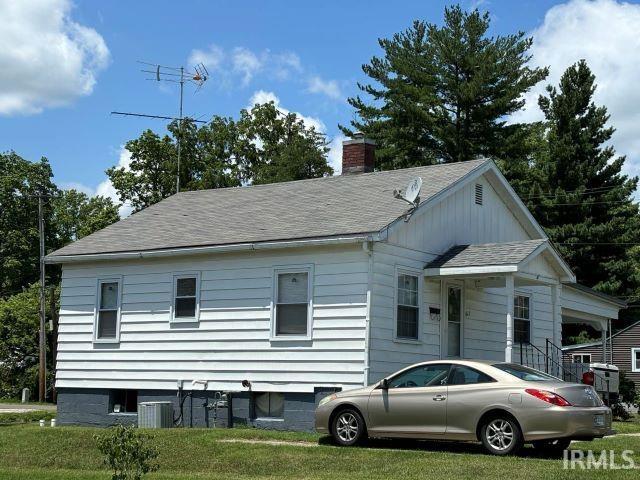 view of front facade featuring a front lawn and central AC unit