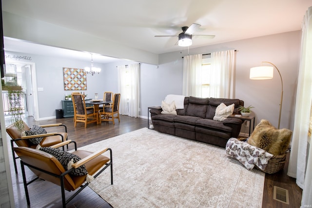 living room featuring hardwood / wood-style flooring, ceiling fan with notable chandelier, and a wealth of natural light