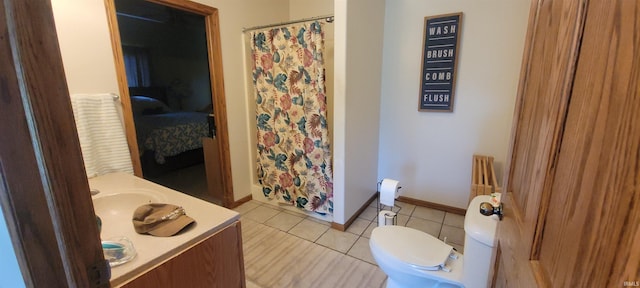 bathroom with tile patterned flooring, vanity, toilet, and a shower with curtain