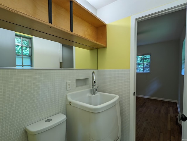 bathroom featuring hardwood / wood-style floors, sink, tile walls, and toilet