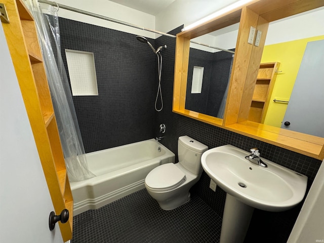 full bathroom with shower / tub combo with curtain, sink, tile patterned floors, and toilet