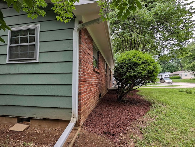 view of property exterior with a yard