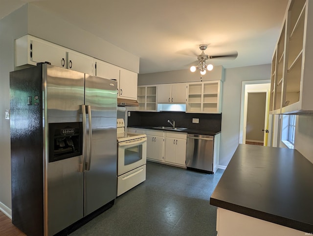 kitchen with sink, ceiling fan, appliances with stainless steel finishes, backsplash, and white cabinets