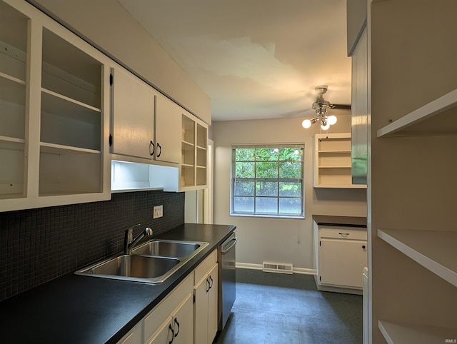 kitchen featuring tasteful backsplash, white cabinetry, dishwasher, and sink