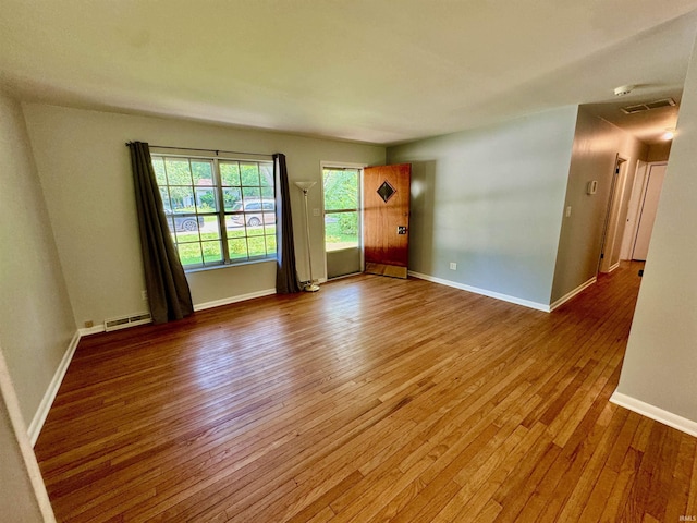 unfurnished room featuring hardwood / wood-style flooring