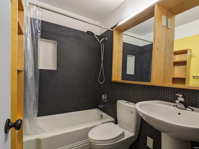 full bathroom featuring shower / bathtub combination with curtain, sink, and toilet