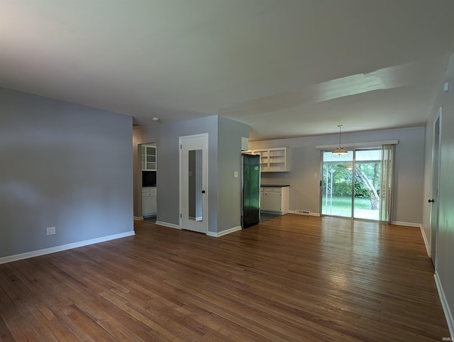 unfurnished living room with dark hardwood / wood-style flooring