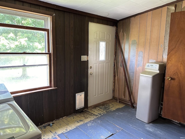 foyer entrance with independent washer and dryer and wooden walls