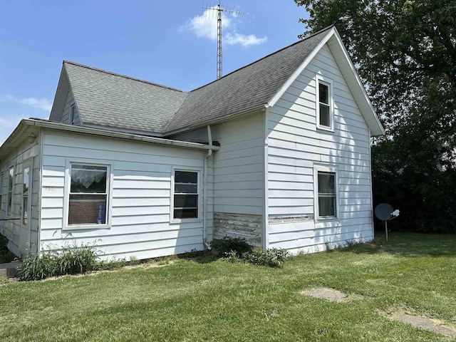 view of side of home featuring a yard